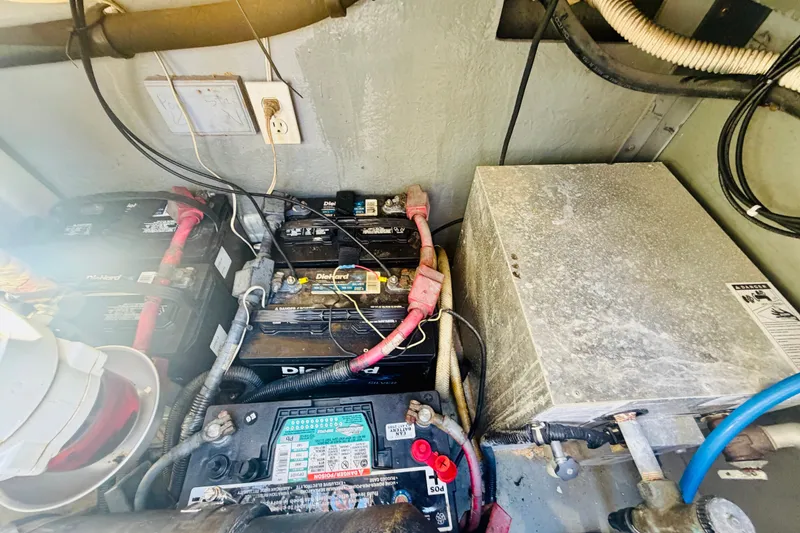 Slide: The Image of Engine compartment of a 2000 Sea Ray 410 Sundancer showing batteries and electrical components. - 54