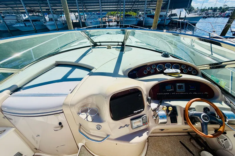 Slide: The Image of Cockpit view of 2000 Sea Ray 410 Sundancer yacht with steering wheel and control panel. - 16