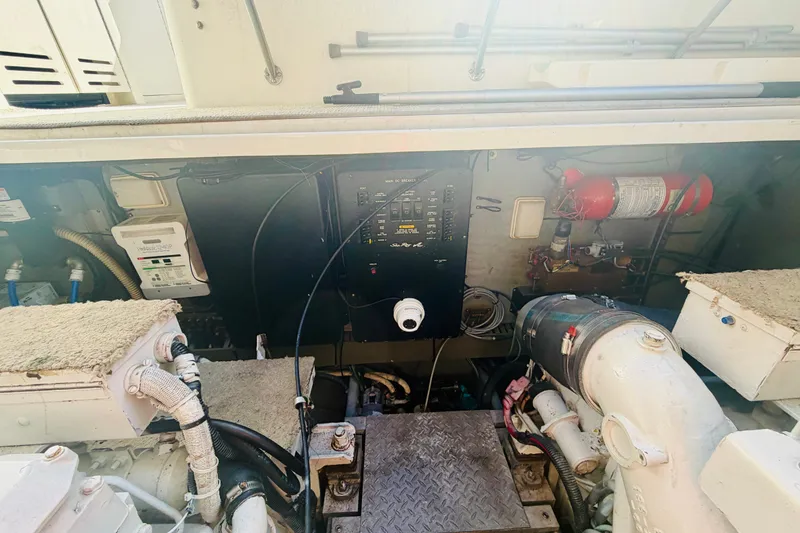 Slide: The Image of Engine room of a 2000 Sea Ray 410 Sundancer with control panel and fire extinguisher. - 52