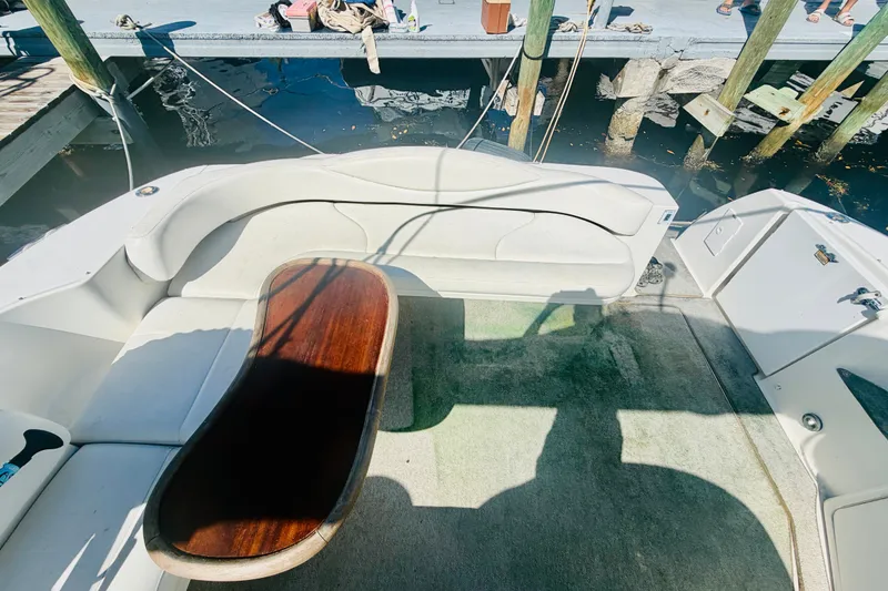 Slide: The Image of 2000 Sea Ray 410 Sundancer boat interior with seating and wooden table. - 33