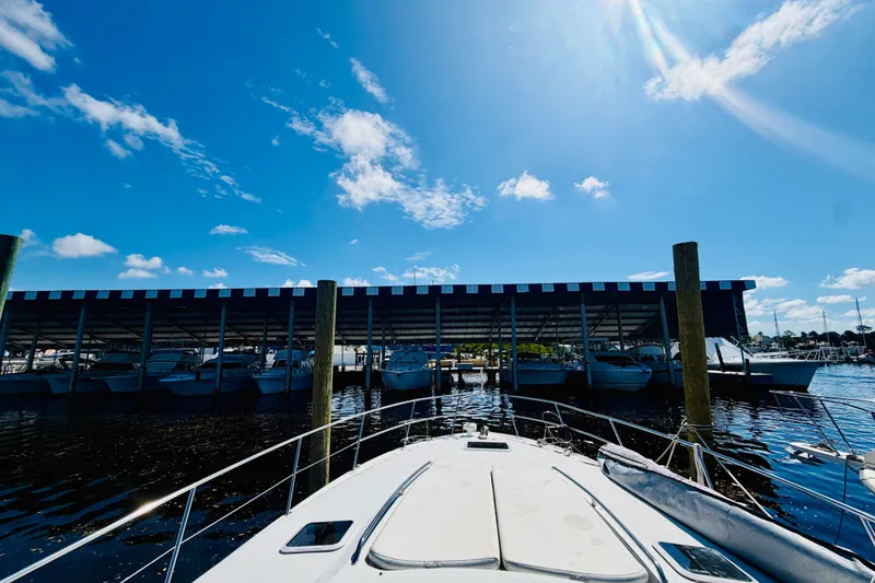 Slide: The Image of 2000 Sea Ray 410 Sundancer docked under a sunny blue sky at a marina. - 19