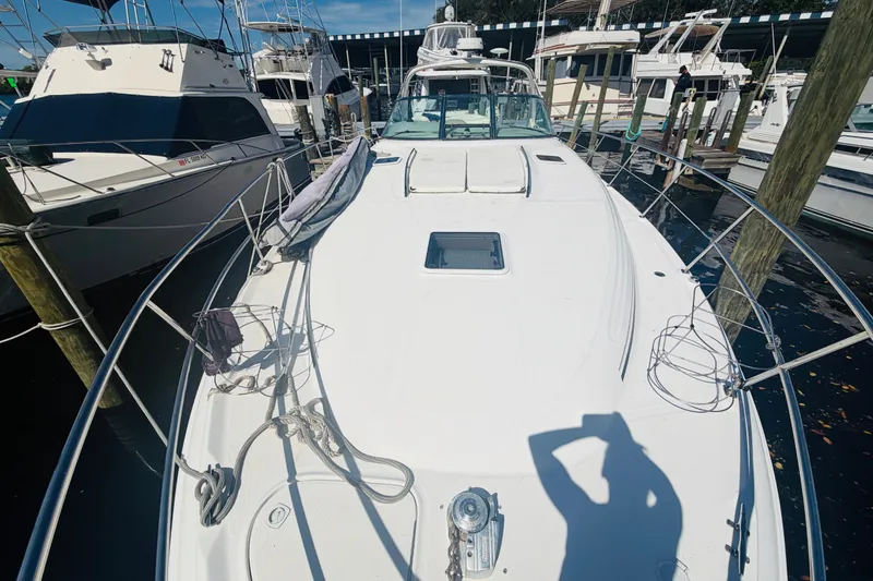 Slide: The Image of 2000 Sea Ray 410 Sundancer yacht docked at marina, surrounded by other boats. - 26