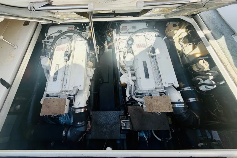 Slide: The Image of Engine compartment of a 2000 Sea Ray 410 Sundancer boat, featuring dual engines. - 50