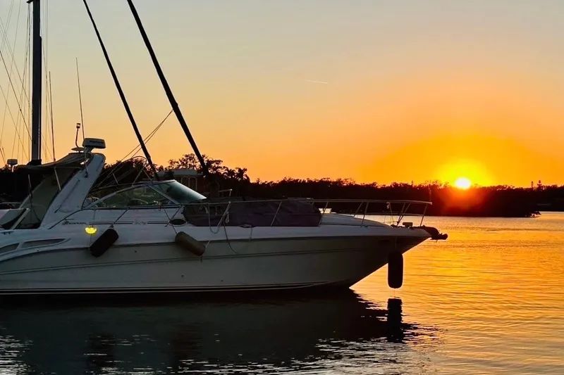 Slide: The Image of Sea Ray 410 Sundancer 2000 yacht at sunset on tranquil water. - 69