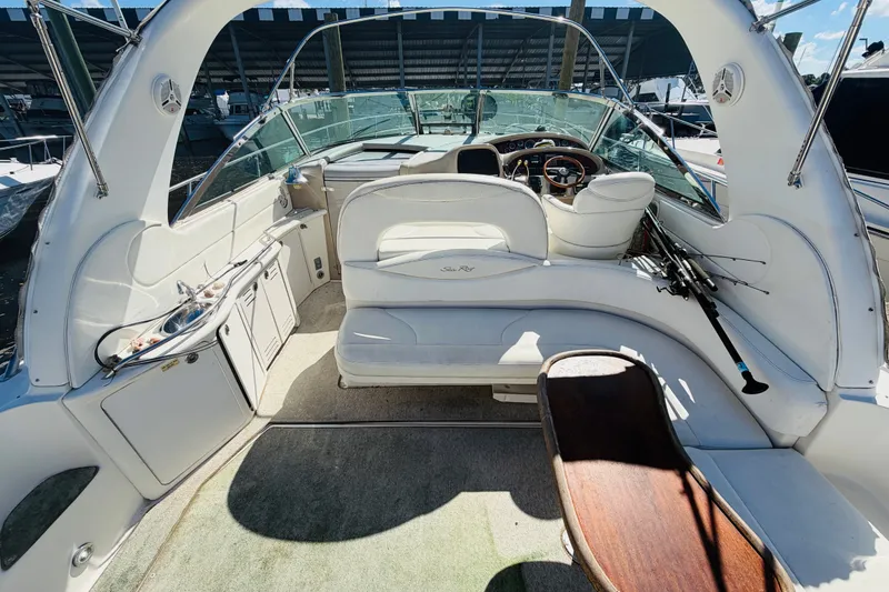 Slide: The Image of Interior view of a 2000 Sea Ray 410 Sundancer yacht, featuring white seating and helm. - 11