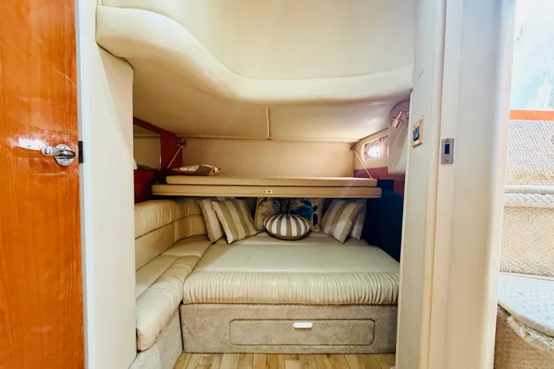 Slide: The Image of Interior cabin of 2000 Sea Ray 410 Sundancer with cozy seating and cushions. - 65