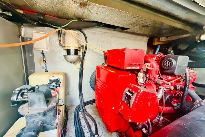 Slide: The Image of Engine room of a 2000 Sea Ray 410 Sundancer with red machinery and wiring. - 53