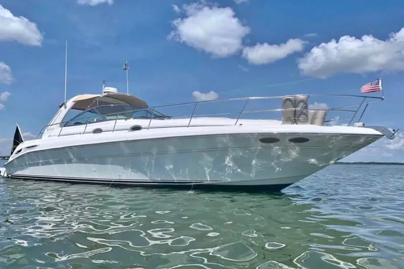 The Image of 2000 Sea Ray 410 Sundancer yacht on calm water under a clear blue sky. - 3
