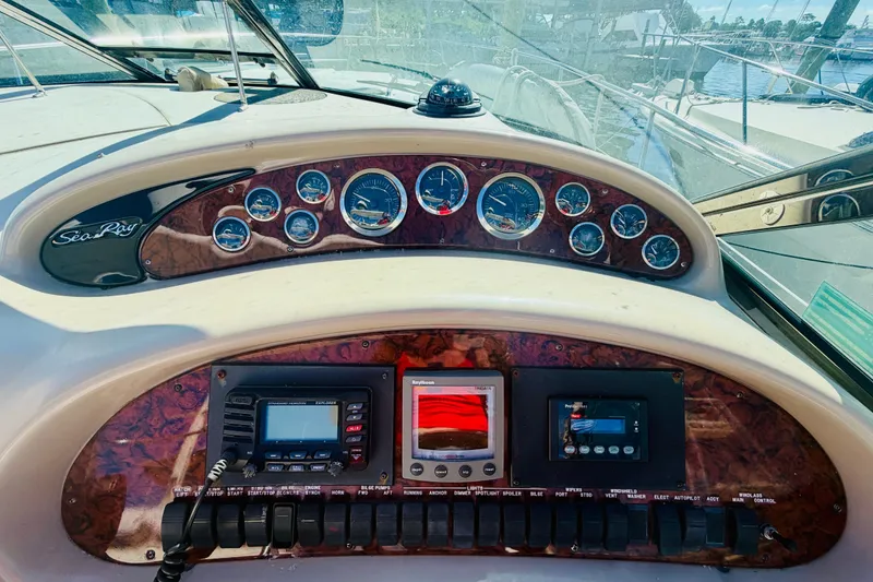 Slide: The Image of Dashboard of a 2000 Sea Ray 410 Sundancer boat with gauges and controls. - 39