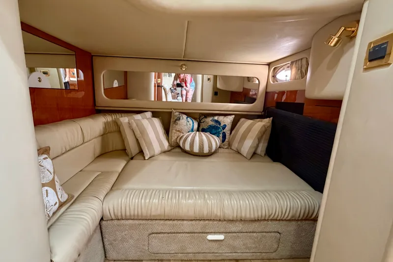 Slide: The Image of Luxurious interior of 2000 Sea Ray 410 Sundancer yacht with plush seating and decorative pillows. - 64
