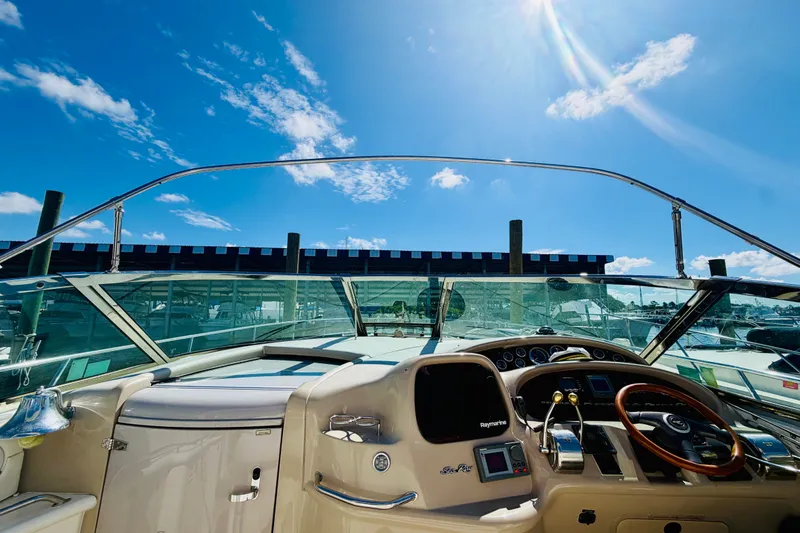 Slide: The Image of Cockpit view of 2000 Sea Ray 410 Sundancer under clear blue sky. - 15