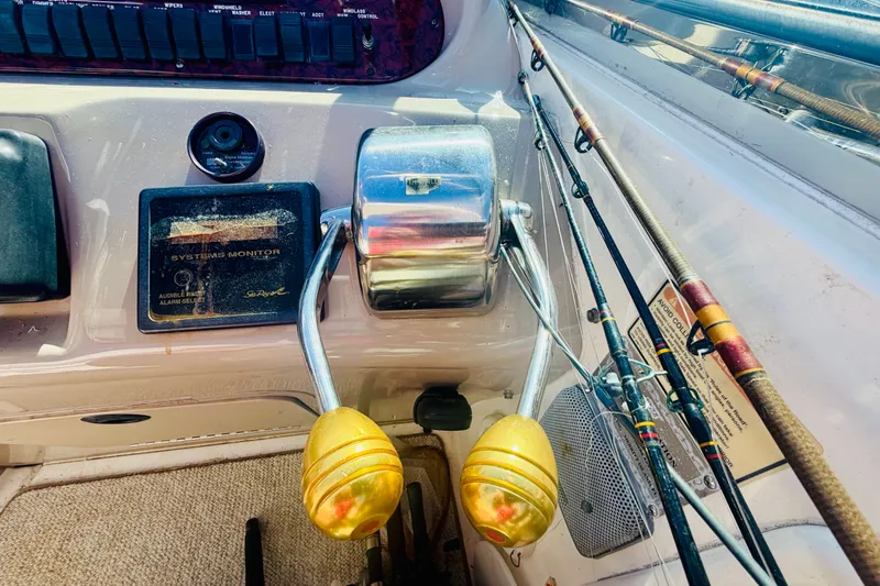 Slide: The Image of Close-up of Sea Ray 410 Sundancer 2000 boat controls and fishing rods. - 41