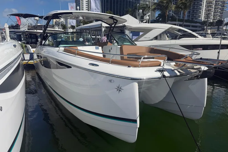 Slide: The Image of 2027 Jeanneau TH33 luxury yacht docked at marina, showcasing sleek design and modern features. - 1