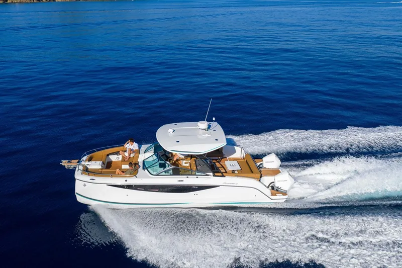 Slide: The Image of 2027 Jeanneau TH33 yacht cruising on open blue sea. - 5