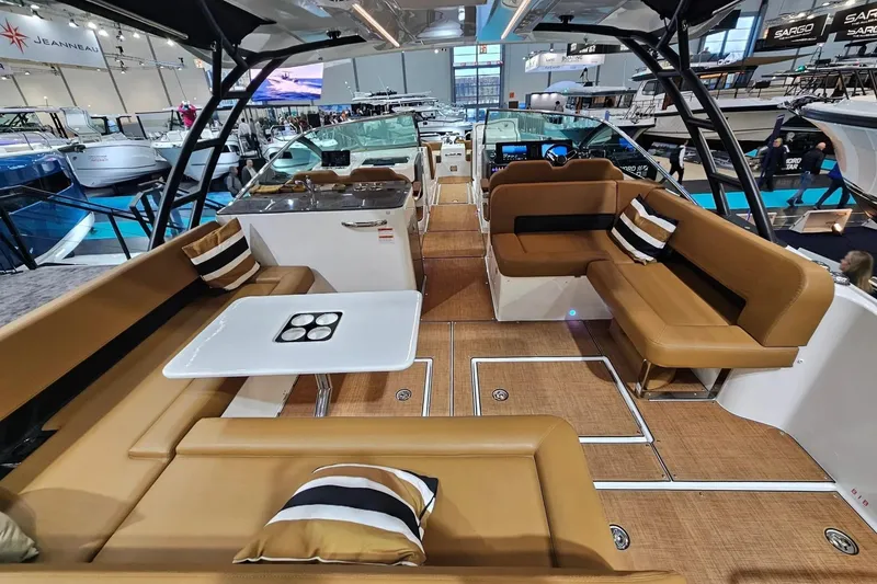 Slide: The Image of Luxurious Jeanneau TH33 2027 yacht interior with tan seating and modern amenities. - 3