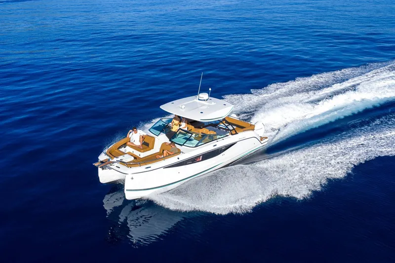 Slide: The Image of 2027 Jeanneau TH33 yacht cruising on open blue sea, showcasing sleek design and luxury. - 4