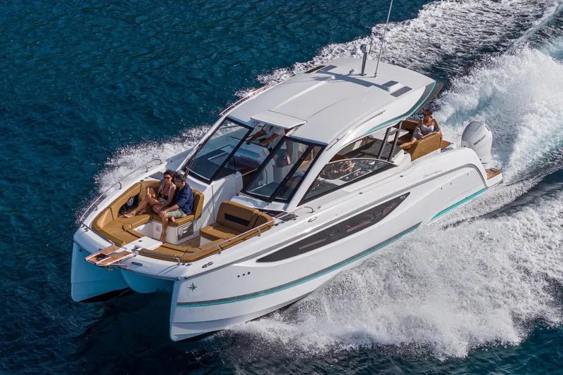 Slide: The Image of 2027 Jeanneau TH38 motor yacht cruising on blue ocean waters. - 3