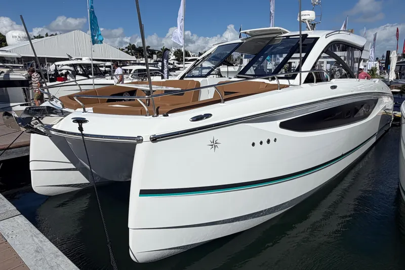 Slide: The Image of 2027 Jeanneau TH38 luxury yacht docked at marina under clear skies. - 1