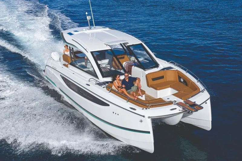 Slide: The Image of 2027 Jeanneau TH38 cruising on open water with passengers enjoying the ride. - 2