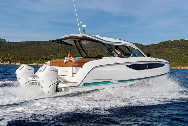 Slide: The Image of 2027 Jeanneau TH38 motor yacht cruising on open water with scenic background. - 5