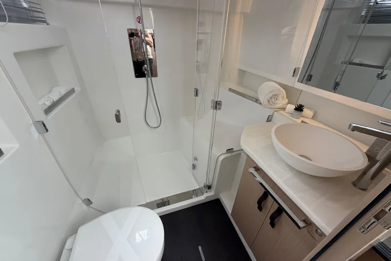 Slide: The Image of Modern bathroom in 2027 Jeanneau TH38 yacht with shower, sink, and toilet. - 8