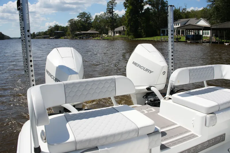 Slide: The Image of 2024 Costa Custom Boats 264HC with dual Mercury engines on a scenic river. - 37