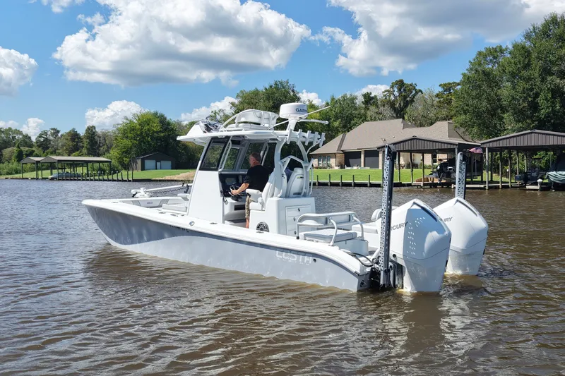 Slide: The Image of 2024 Costa Custom Boats 264HC on a serene lake, showcasing sleek design and powerful engines. - 18