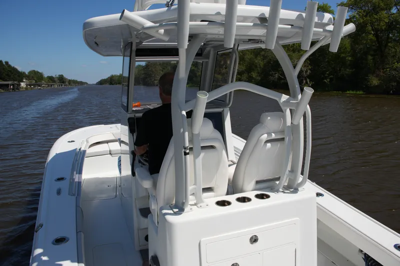 Slide: The Image of 2024 Costa Custom Boats 264HC cruising on a scenic river under clear skies. - 41