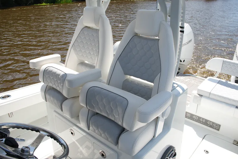 Slide: The Image of 2024 Costa Custom Boats 264HC interior with luxurious seating on a calm river. - 34