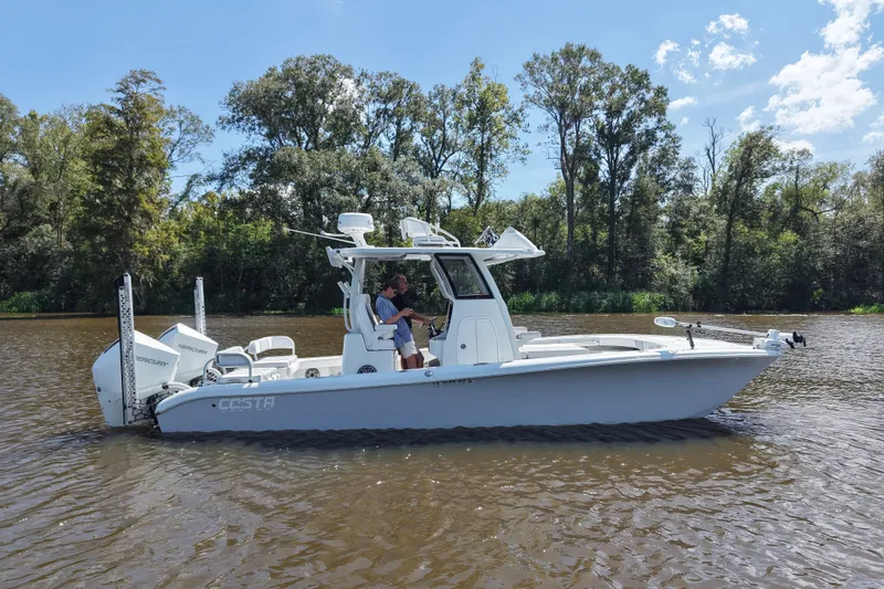 Slide: The Image of 2024 Costa Custom Boats 264HC on a serene river, surrounded by lush trees. - 19