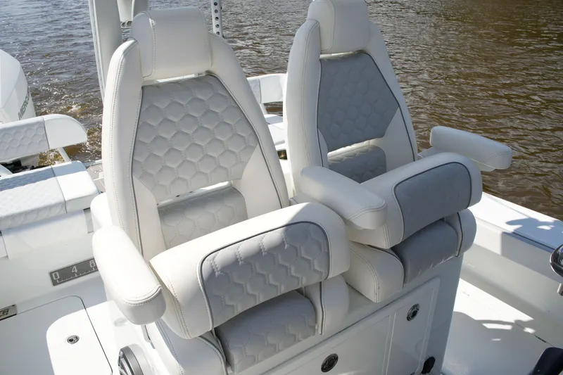 Slide: The Image of 2024 Costa Custom Boats 264HC luxury seating with hexagonal pattern on a boat. - 29