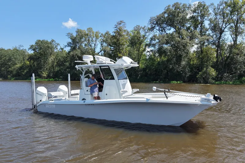 Slide: The Image of 2024 Costa Custom Boats 264HC on a serene river with lush trees in the background. - 12