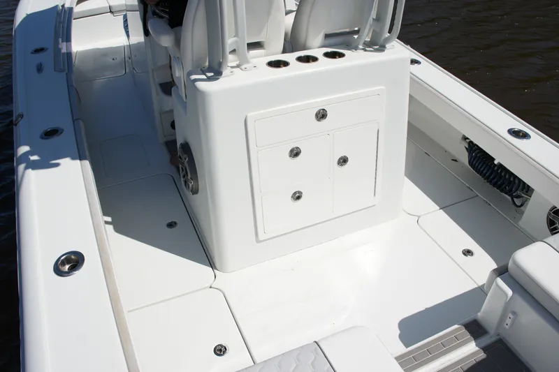 Slide: The Image of 2024 Costa Custom Boats 264HC interior with white seating and storage compartments. - 40