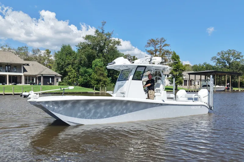 Slide: The Image of 2024 Costa Custom Boats 264HC on a serene river with lush greenery. - 1