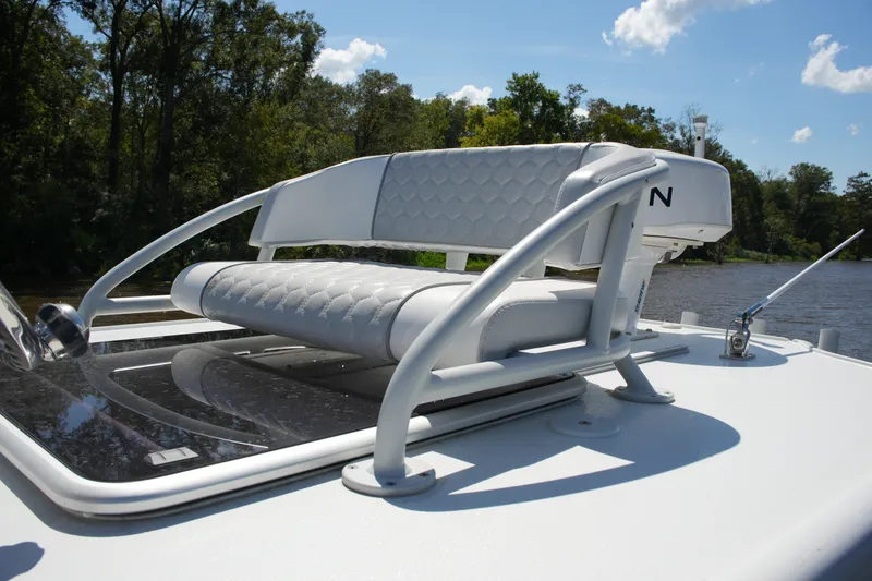 Slide: The Image of 2024 Costa Custom Boats 264HC helm seat with sleek design on a sunny day. - 52