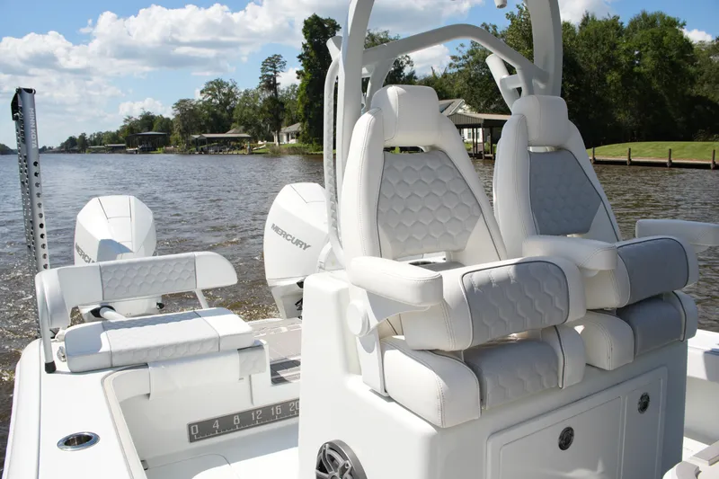 Slide: The Image of 2024 Costa Custom Boats 264HC with luxurious seating and dual Mercury engines on a scenic river. - 28