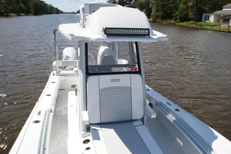 Slide: The Image of 2024 Costa Custom Boats 264HC on a scenic river, showcasing sleek design and modern features. - 26