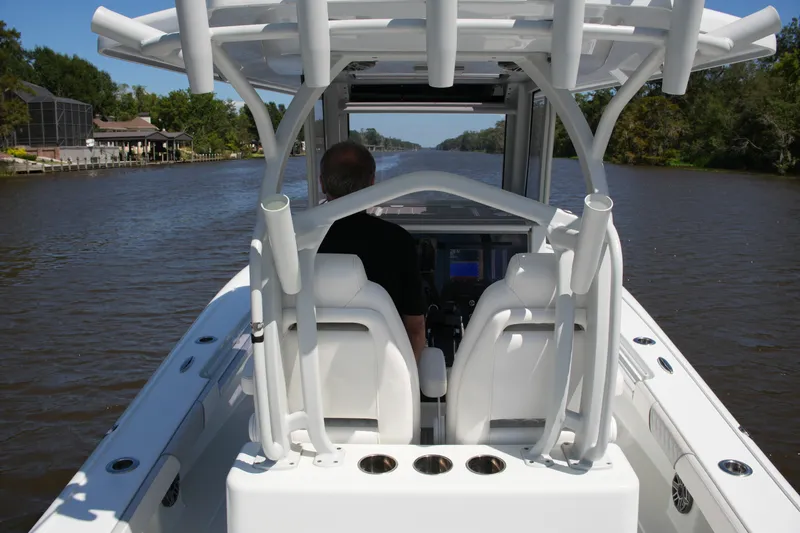 Slide: The Image of 2024 Costa Custom Boats 264HC cruising on a scenic river, showcasing sleek design and comfort. - 44