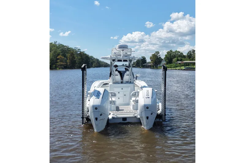 Slide: The Image of 2024 Costa Custom Boats 264HC on a serene river under a blue sky. - 6