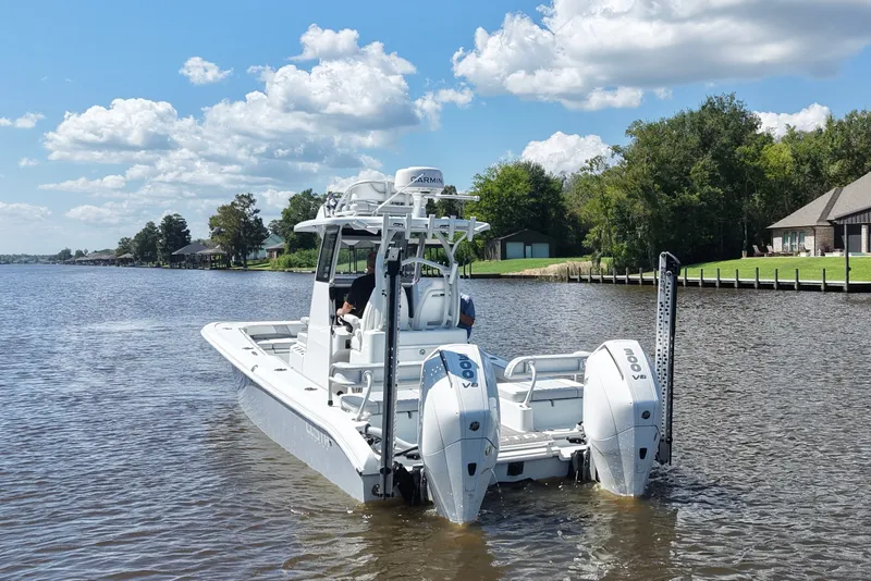 Slide: The Image of 2024 Costa Custom Boats 264HC on a scenic river with clear skies. - 5