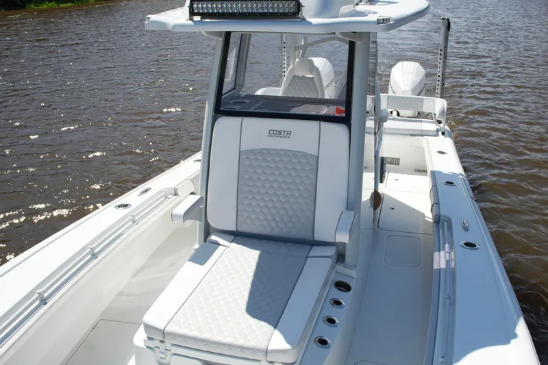 Slide: The Image of 2024 Costa Custom Boats 264HC on water, featuring sleek design and comfortable seating. - 24
