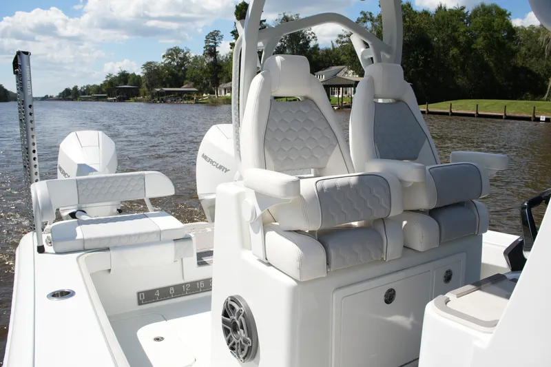 Slide: The Image of 2024 Costa Custom Boats 264HC interior with luxurious seating on a scenic river. - 27