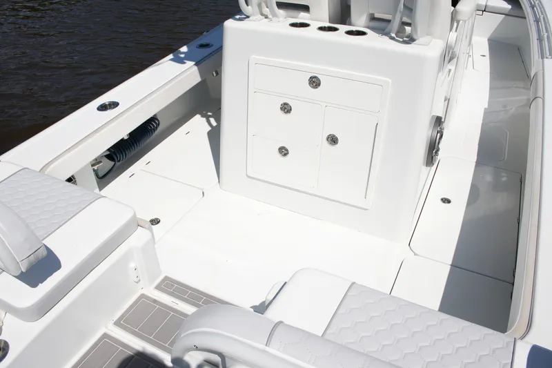 Slide: The Image of 2024 Costa Custom Boats 264HC interior, featuring sleek white seating and storage compartments. - 38