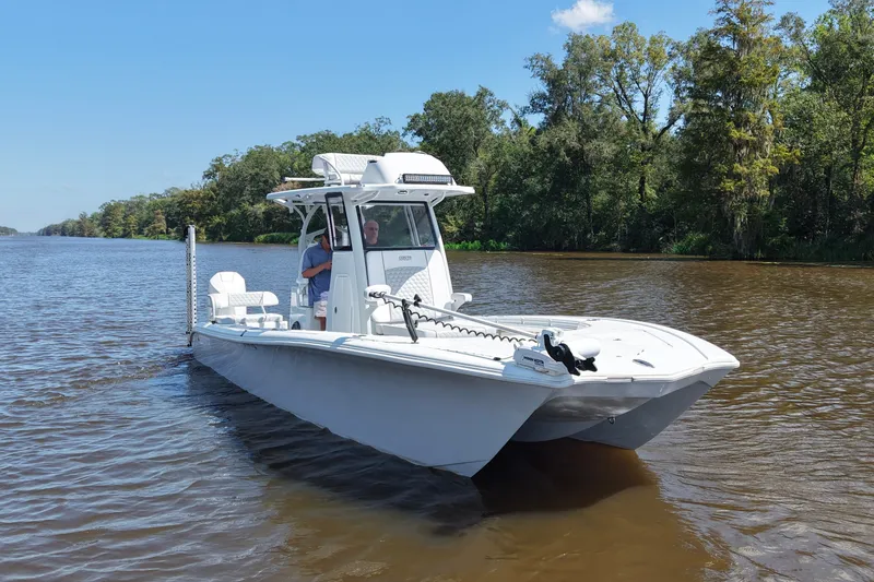 Slide: The Image of 2024 Costa Custom Boats 264HC on a serene river, surrounded by lush greenery. - 13