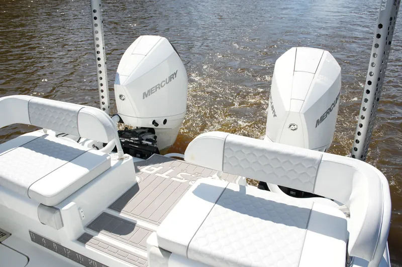 Slide: The Image of 2024 Costa Custom Boats 264HC with dual Mercury outboard engines on water. - 35