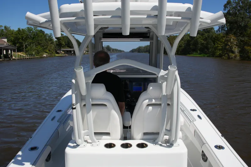Slide: The Image of 2024 Costa Custom Boats 264HC navigating a scenic river, showcasing sleek design and modern features. - 42