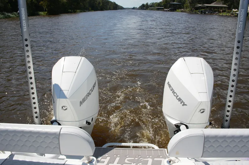Slide: The Image of 2024 Costa Custom Boats 264HC with dual Mercury engines on a river. - 36