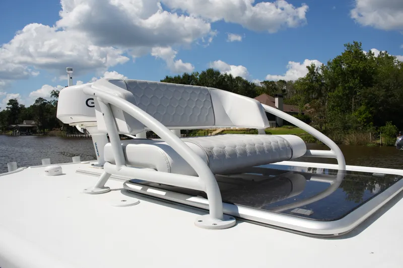 Slide: The Image of 2024 Costa Custom Boats 264HC helm seat on deck, under a partly cloudy sky. - 51