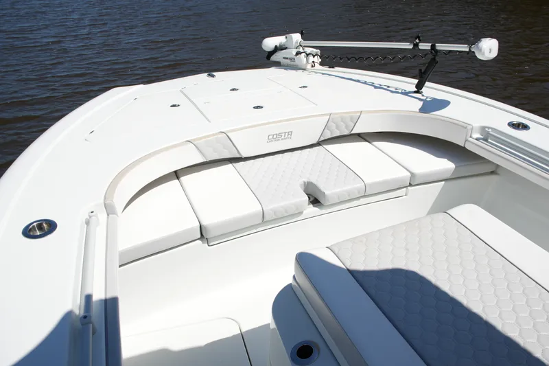 Slide: The Image of 2024 Costa Custom Boats 264HC, featuring sleek seating and modern design on calm waters. - 23
