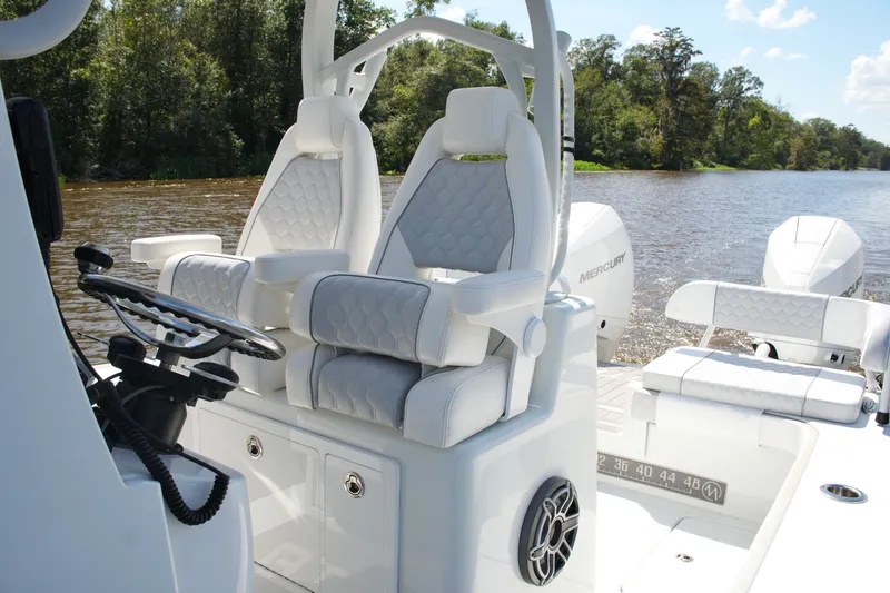 Slide: The Image of 2024 Costa Custom Boats 264HC with luxurious seating on a scenic river. - 33